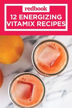 two glasses filled with orange juice on top of a marble counter