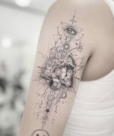 a woman's arm with a tattoo on it and an eye in the middle