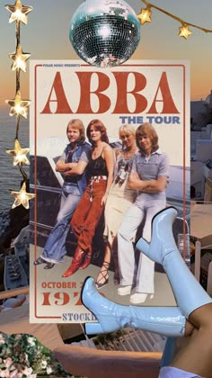 an advertisement for the abra tour is displayed in front of a disco ball