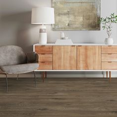 a living room scene with focus on the sideboard and chair in the foreground