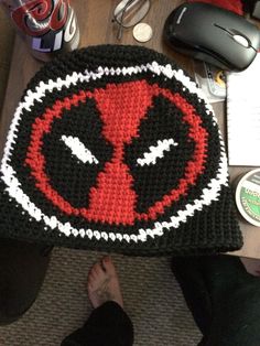 a knitted deadpool hat sitting on top of a table