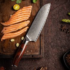 fish fillets on a cutting board with a knife next to them and spices around it