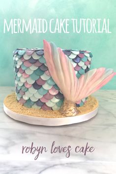 the cake is made to look like a mermaid's tail with pink and blue scales