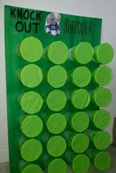 a green bulletin board with lots of circles on it and the words knock out in black