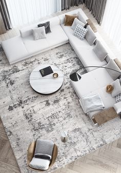 an aerial view of a living room with couches, coffee tables and rugs