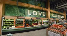 the produce section of a grocery store with lots of fresh fruits and vegetables on display