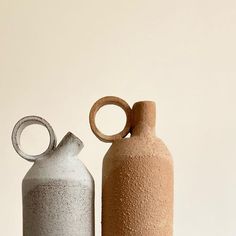 two vases sitting next to each other on a table