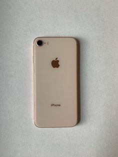 an iphone sitting on top of a white table