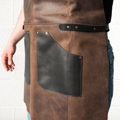 If you're a wood carver, artist, electrician, mechanic, butcher, chef, barber, or barista and value comfort and style in your workwear, then this AP3X Adjustable Leather Work Apron will not go unnoticed. This heavy-duty leather work apron model is designed to be the perfect gear to protect against dirt and injury and to become an important addition to your work look. This stylish work apron you see in front of you is crafted from high-quality brown and black leather that looks better and better Butcher Apron, All Instruments, Apron Ideas, Tool Apron, Work Apron, Work Accessories, Work Aprons, Leather Apron, Wood Carver