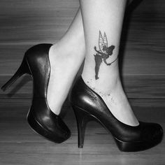 a woman's foot with a small tattoo on her left leg and a fairy tale design on the ankle