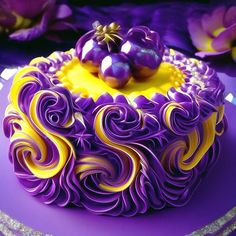 a purple and yellow cake sitting on top of a table