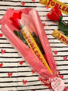 valentine's day gift wrapped in pink paper with roses and chocolate bar wrapper