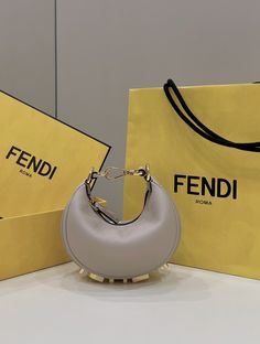 Description FND FNDgraphy Beige Mini Shoulder Bag For Woman 16.5cm/6.5in Rep 1:1 Size: 16.5 x 14 x 5 cm / 6.5 x 5.5 x 1.5 inch Mini hobo bag made of soft beige leather, decorated with vintage gold metal FND lettering visible when wearing the bag under the arm. Zipper closure with fabric-lined internal compartment, gold-finish metalware. Can be worn under the arm or cross-body thanks to the adjustable, detachable handle and the hooks that allow a shoulder strap to be attached. Beige Mini Includes box, dust bag. This product is of the best quality. Fendi Mini Bag, Mini Hobo Bag, Dream Bags, Leather Decor, Soft Beige, Handbag Wallet, Mini Shoulder Bag, Wallet Accessories, Christmas Bags