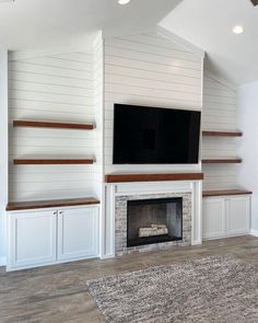 a fireplace with built in shelves and a flat screen tv above it