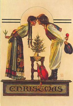 a christmas card with two women kissing in front of a tree and stockings on the mantle