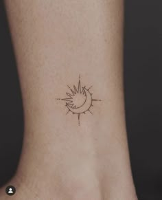 a small sun and moon tattoo on the side of a woman's foot,