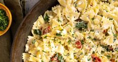 a bowl filled with pasta and vegetables on top of a table