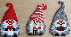 three gnomes made out of beads sitting on a table