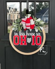 the front door is decorated with wreaths, stockings and christmas decorations that say i'm this house we are oh 10