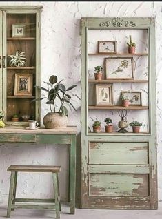 an old green desk and chair with potted plants