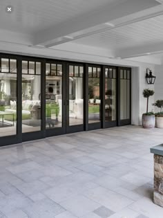 an empty room with glass doors and chairs