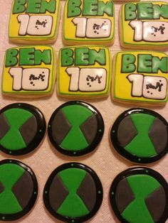 six decorated cookies with green and black designs on top of a table next to each other