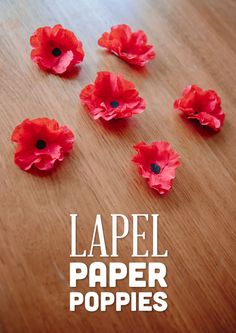 paper poppys on a wooden table with text that reads lapel paper poppies