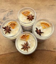 four glasses filled with orange slices and star anise