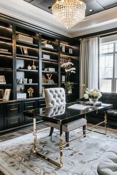 a black and white living room with gold accents, chandelier, leather couches and built - in bookshelves