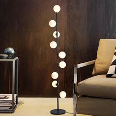 a modern floor lamp in the corner of a living room