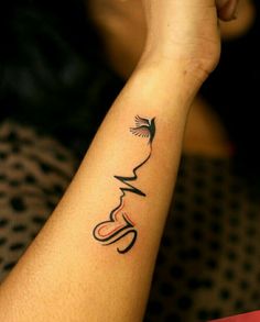 a woman's arm with a tattoo on the wrist and an image of a bird flying over her head