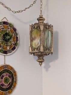 there are three decorative plates hanging on the wall together, one is gold and the other is green