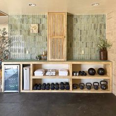 there is a shelf with shoes and other items on it in the living room area