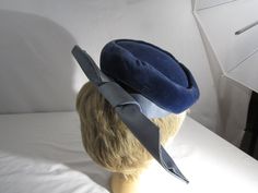 the hat has combs on each side to hold hat in place. Formal Blue Winter Hat, Blue Formal Winter Hat, Vintage Fitted Blue Hats, Vintage Blue Hat For Formal Occasions, Vintage Blue Formal Hat, Blue Fitted Vintage Mini Hats, Cloche Hats, Hat With Bow, Displaying Crystals