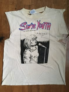 a white t - shirt with an image of a woman singing into a microphone