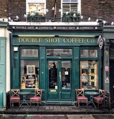 the outside of a coffee shop with chairs and tables