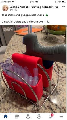 a red sleigh filled with plastic cups on top of a marble countertop