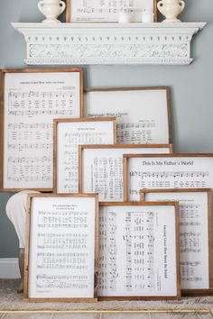 there are many framed sheet music pieces on the floor