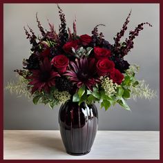 a vase filled with red and purple flowers