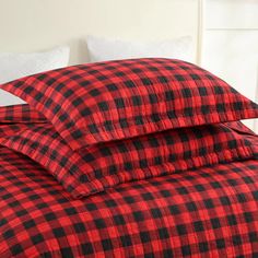 a red and black plaid comforter on a bed