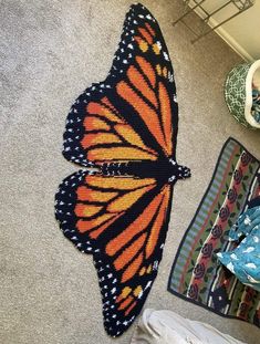 a large butterfly is laying on the floor