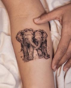 an elephant tattoo is shown on the arm