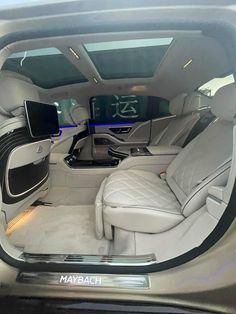 the interior of a car with many seats and electronic devices in it's center console