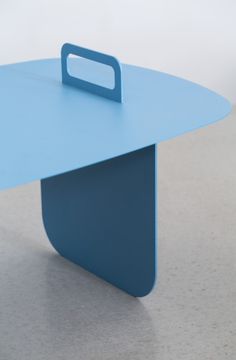 a blue table sitting on top of a white floor