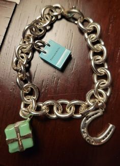 You are purchasing a Tiffany & Co. Charm Bracelet with Three Charms with Original Box 40 Grams 7.5". See pictures of the item you are purchasing. The shipping is free. Tiffany Charm Bracelet, Tiffany And Co Bracelet, Tiffany And Co, Fine Jewelry Bracelets, Bracelets And Charms, See Pictures, Tiffany & Co., Original Box, Jewelry Watches