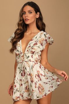 All eyes and hearts will be on you in the Lulus Flirty Ways Cream Floral Print Flutter Sleeve Romper! Lightweight, woven chiffon fabric boasts a purple and green floral print that sweeps across fluttering short sleeves (with hidden no-slip strips), a plunging V-neckline with a matching back, and a pleated bodice. Tying details at the front and back of the banded empire waist tops flowy shorts. Hidden back zipper/clasp. Fit: This garment runs small - please size up. Length: Above mid-thigh. Size Empire Waist Tops, Chiffon Romper, Soft Dramatic, Rompers Dressy, Floral Print Rompers, Flowy Shorts, Green Floral Print, Pleated Bodice, Cute Rompers