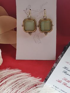 I saw these earrings and knew they were perfect to offer in the shop.  They are gold plated earwires with a square glass green intaglio and pearl elements.  Perfect to wear for late 18th century, early 19th century on up to today.  I love them! They measure 1-1/4 inches long by just over 1/2 inch wide.  The earwire is super long which is good to stay in the ear. Lots of inspiration on my Pinterest page.  https://www.pinterest.com/kkwalte/_saved/ Classic Gold Crystal Earrings Gift, Classic Gold Crystal Earrings For Gift, Victorian Brass Earrings For Party, Antique Gold Earrings For Party, Antique Gold Party Earrings, Elegant Rectangular Clip-on Earrings For Formal Events, Gold Antique Party Earrings, Antique Brass Earrings For Party, Victorian Earrings With Lever Back For Gifts