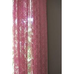 pink sheer curtains hanging on the side of a window