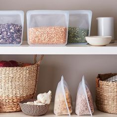 three shelves with baskets, bowls and containers on top of each shelf are filled with cereal