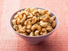 a bowl filled with cashews on top of a table